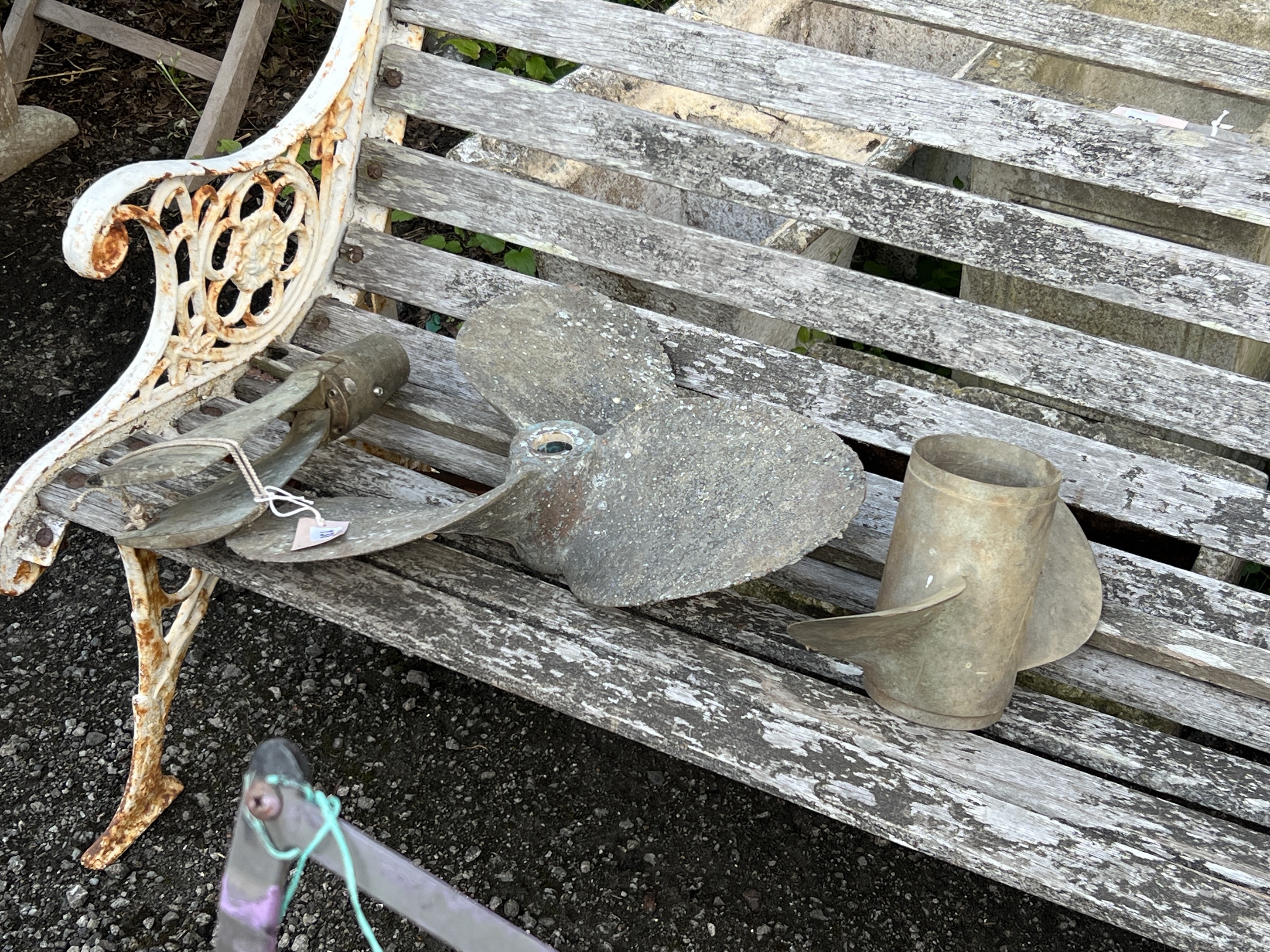 Two vintage brass ship's propellers and an oar rowlock, largest 42cm
